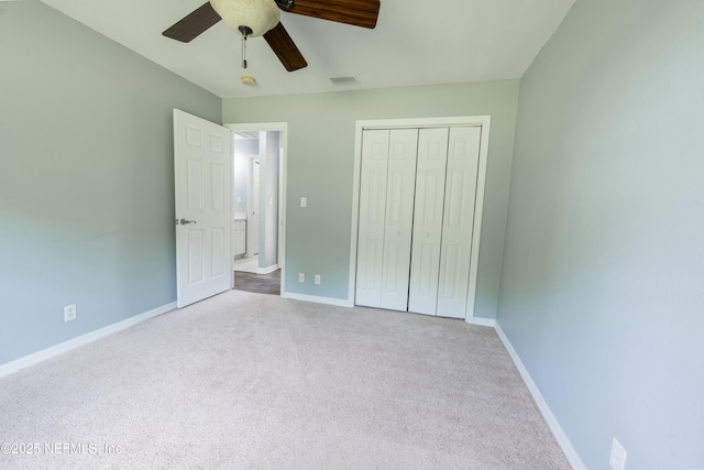 unfurnished bedroom with a ceiling fan, a closet, baseboards, carpet flooring, and visible vents