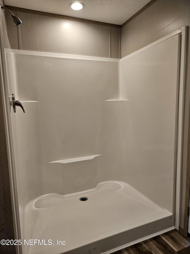 full bathroom with recessed lighting, wood finished floors, and walk in shower