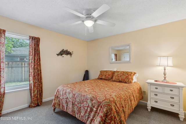 carpeted bedroom featuring ceiling fan and baseboards