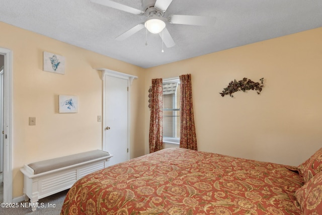 bedroom featuring a ceiling fan and carpet
