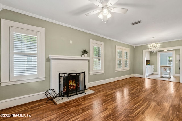 unfurnished living room featuring a fireplace with flush hearth, crown molding, visible vents, baseboards, and wood finished floors