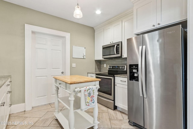 kitchen with white cabinets, wood counters, backsplash, and stainless steel appliances