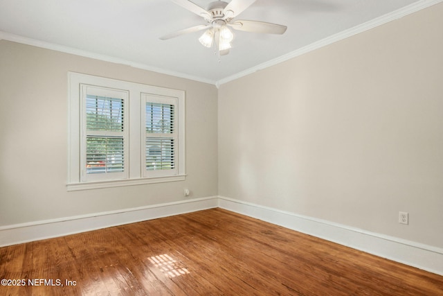 spare room featuring ornamental molding, a ceiling fan, wood finished floors, and baseboards