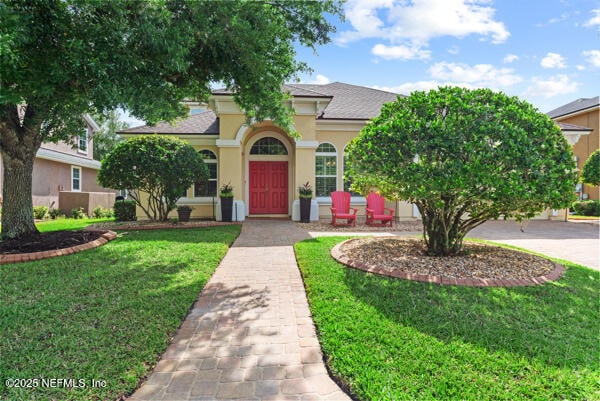 view of front of house featuring a front lawn and stucco siding