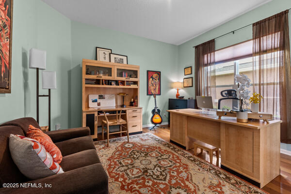 office area with wood finished floors and baseboards