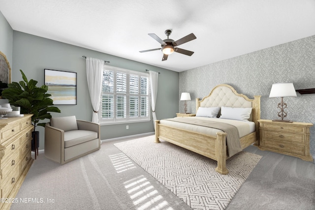 9831 Del Webb Pkwy Unit 1302, Jacksonville, FL 32256 - bedroom featuring wallpapered walls, light colored carpet, baseboards, and a ceiling fan