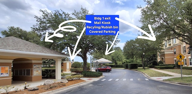 9831 Del Webb Pkwy Unit 1302, Jacksonville, FL 32256 - view of asphalt road featuring curbs, traffic signs, sidewalks, and street lights