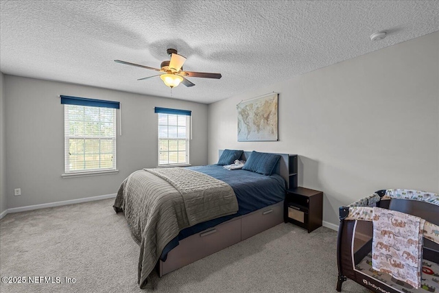 425 Oasis Ln, Orange Park, FL 32073 - carpeted bedroom with baseboards, a ceiling fan, and a textured ceiling