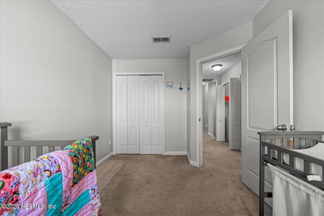 425 Oasis Ln, Orange Park, FL 32073 - carpeted bedroom with baseboards, visible vents, a textured ceiling, and a closet