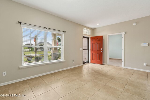 spare room with baseboards, recessed lighting, and light tile patterned flooring
