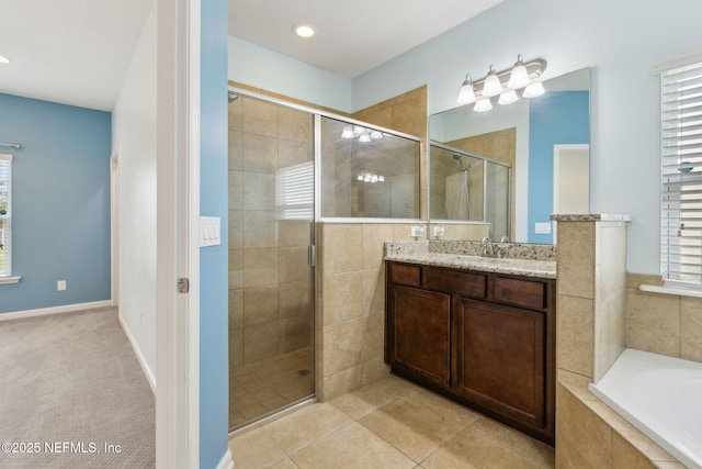 bathroom with vanity, plenty of natural light, and a stall shower