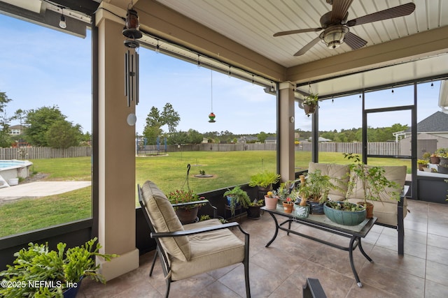 sunroom featuring a ceiling fan and a wealth of natural light
