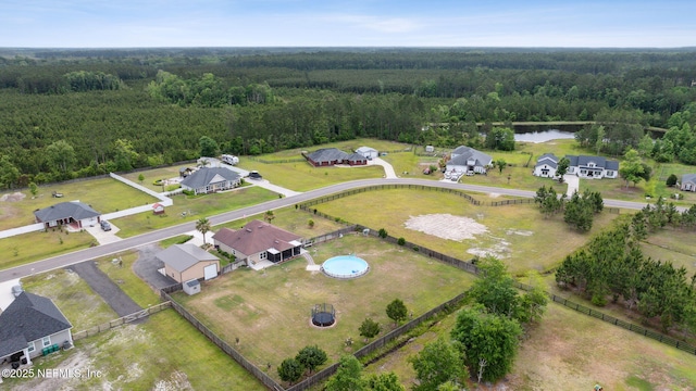 bird's eye view featuring a water view and a wooded view