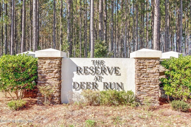 community sign with a wooded view