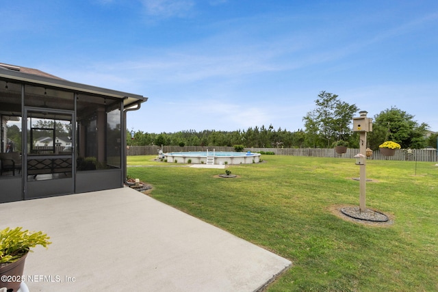 view of yard with a patio, a fenced in pool, a fenced backyard, and a sunroom