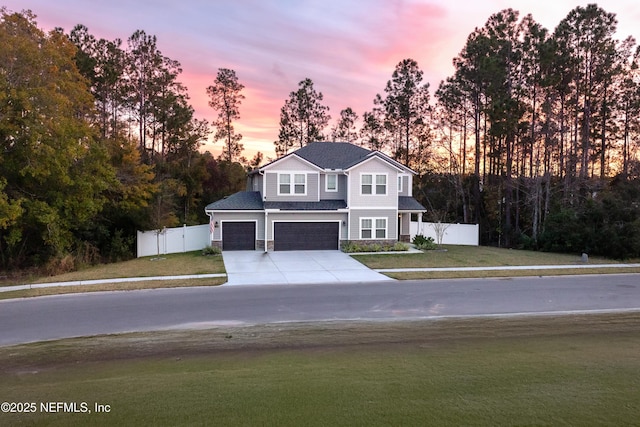 1209 Hammock Dunes Dr, Jacksonville, FL 32221 - view of front facade featuring fence, a garage, driveway, stone siding, and a front lawn