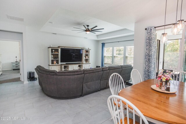 1209 Hammock Dunes Dr, Jacksonville, FL 32221 - dining room with light tile patterned flooring, a ceiling fan, visible vents, and a tray ceiling