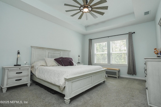 1209 Hammock Dunes Dr, Jacksonville, FL 32221 - bedroom with baseboards, visible vents, dark carpet, and a tray ceiling