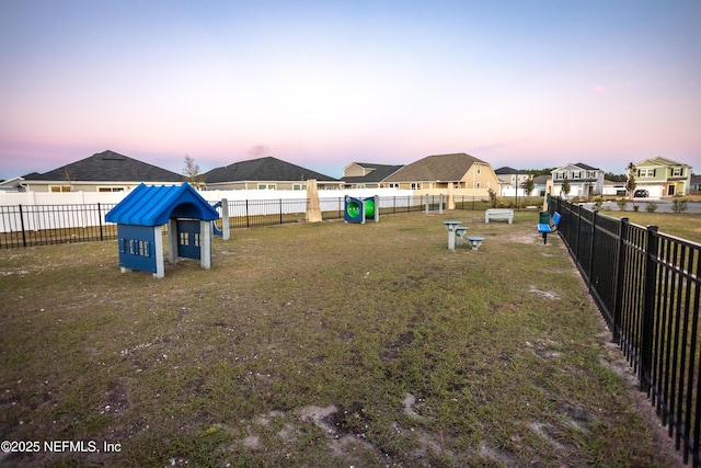 1209 Hammock Dunes Dr, Jacksonville, FL 32221 - yard at dusk featuring fence and a residential view