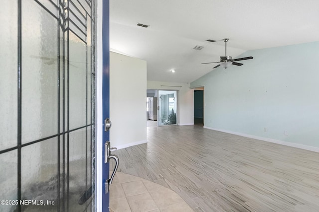 interior space with lofted ceiling, visible vents, baseboards, wood finished floors, and a ceiling fan