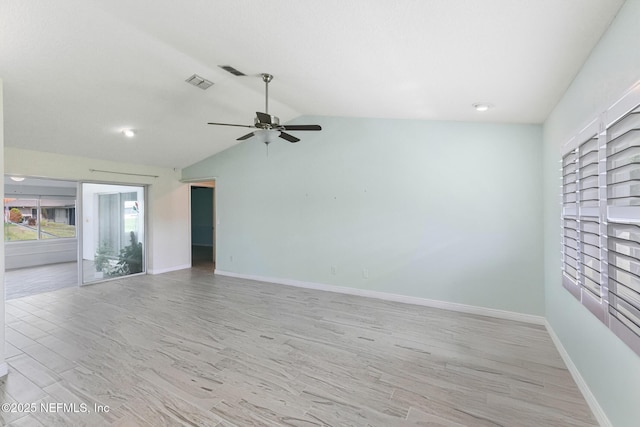 unfurnished room with light wood finished floors, ceiling fan, vaulted ceiling, and visible vents