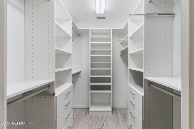 spacious closet with light wood finished floors and visible vents
