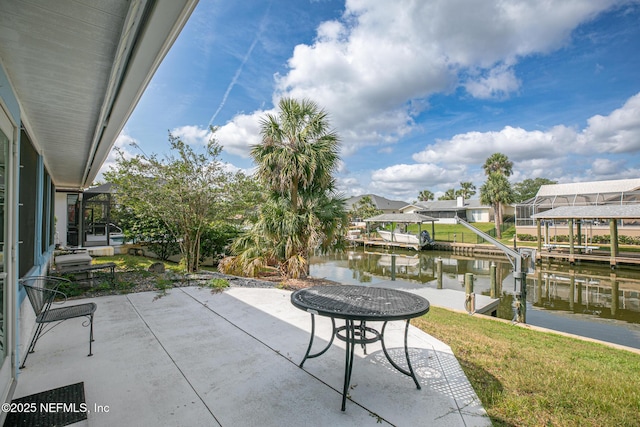 view of patio / terrace featuring a water view, a dock, and boat lift