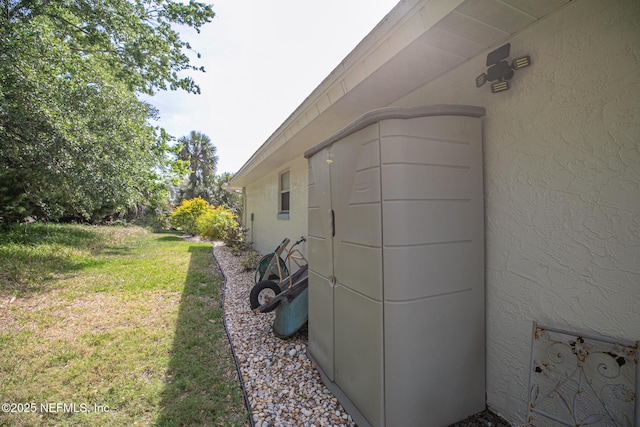 view of property exterior featuring stucco siding and a lawn