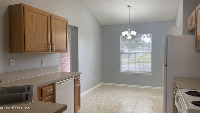 kitchen with an inviting chandelier, a sink, light tile patterned floors, white appliances, and pendant lighting