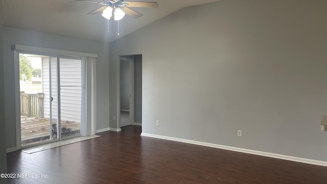 empty room with dark wood-style floors, a ceiling fan, vaulted ceiling, and baseboards