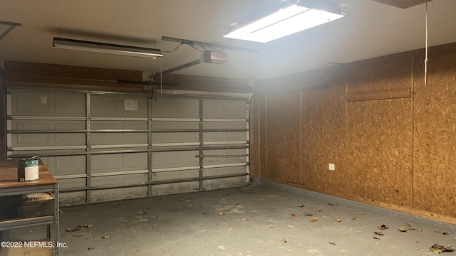 garage with baseboards and a garage door opener