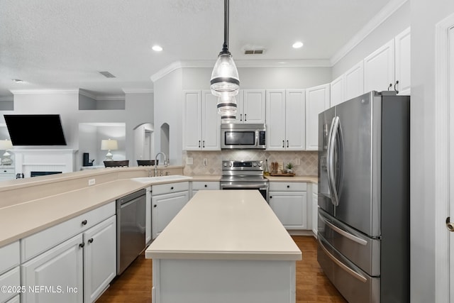 kitchen featuring a sink, visible vents, white cabinetry, dark wood-type flooring, and appliances with stainless steel finishes