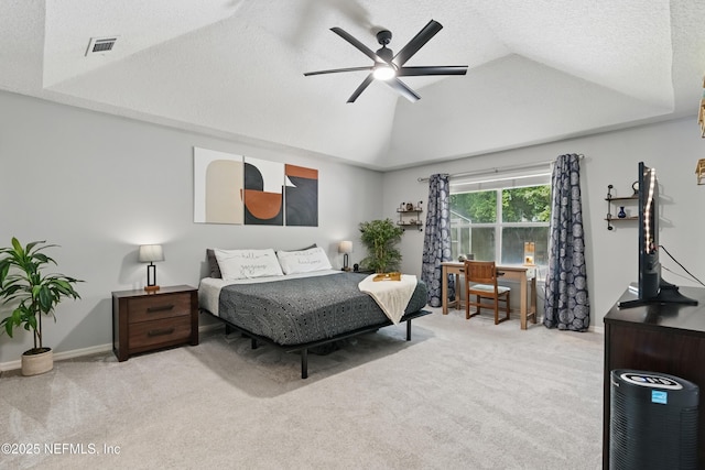 bedroom featuring vaulted ceiling, visible vents, carpet floors, and a ceiling fan