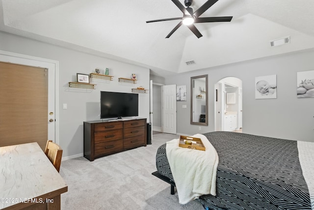 bedroom featuring arched walkways, vaulted ceiling, visible vents, and light colored carpet