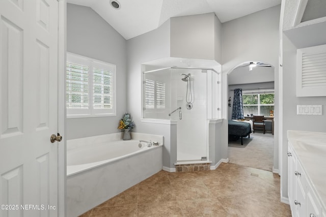 ensuite bathroom featuring a bath, vanity, vaulted ceiling, a shower stall, and ensuite bath