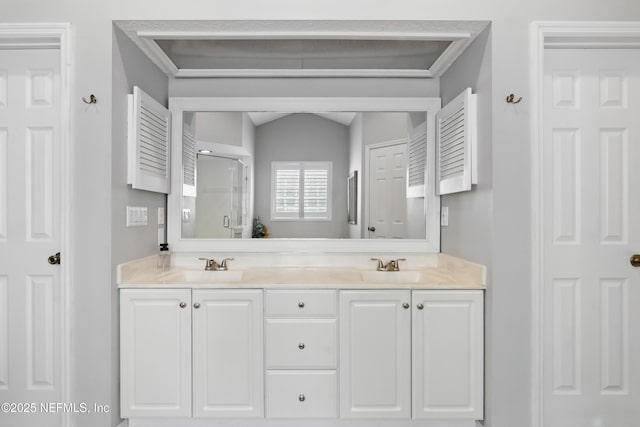 full bath featuring a sink, double vanity, and a stall shower