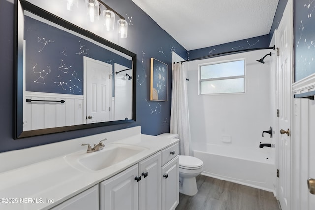 full bath with wood finished floors, vanity, toilet, and shower / bath combo