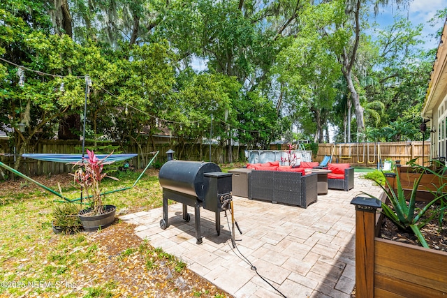 view of patio featuring a fenced backyard and an outdoor living space