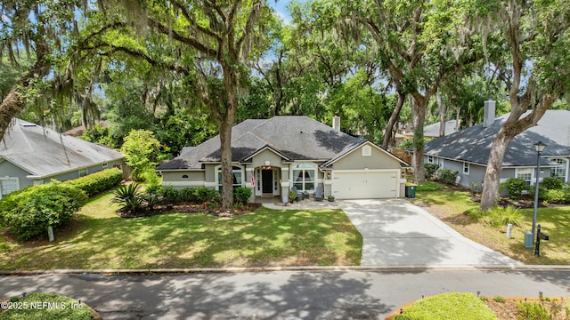 view of front of house with a garage, driveway, a front lawn, and stucco siding