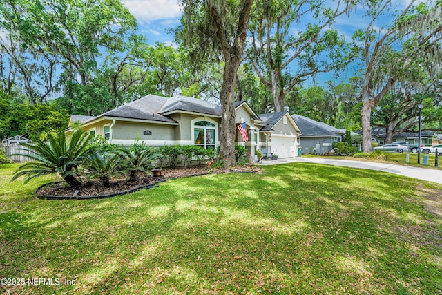 ranch-style home featuring stucco siding, a front yard, a garage, and concrete driveway
