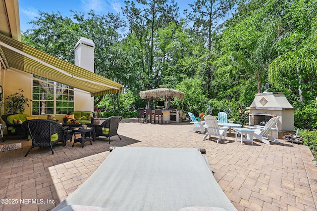 104 Twin Cedar Ct, Ponte Vedra Beach, FL 32082 - view of patio / terrace featuring outdoor dining area and an outdoor living space with a fireplace