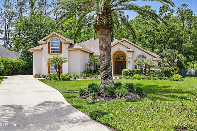 104 Twin Cedar Ct, Ponte Vedra Beach, FL 32082 - view of front of house with concrete driveway, a front yard, stucco siding, and fence
