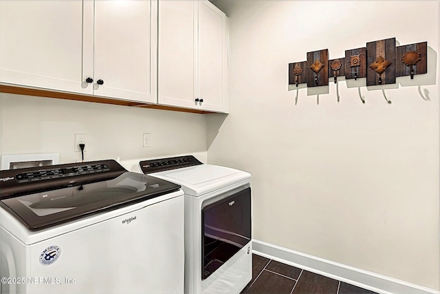laundry area with baseboards, washer and dryer, and cabinet space