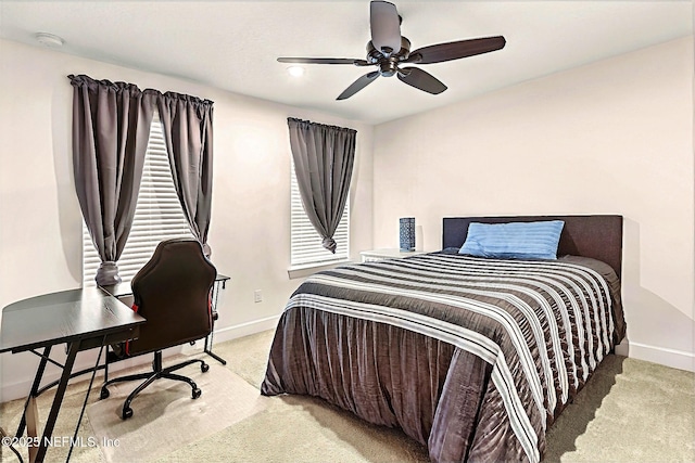 carpeted bedroom featuring baseboards and ceiling fan