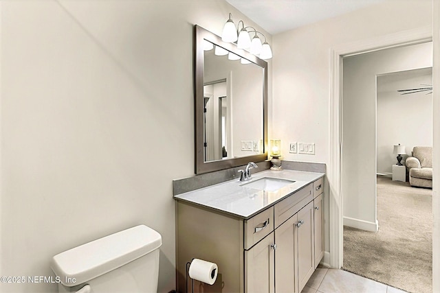 bathroom with baseboards, toilet, and vanity