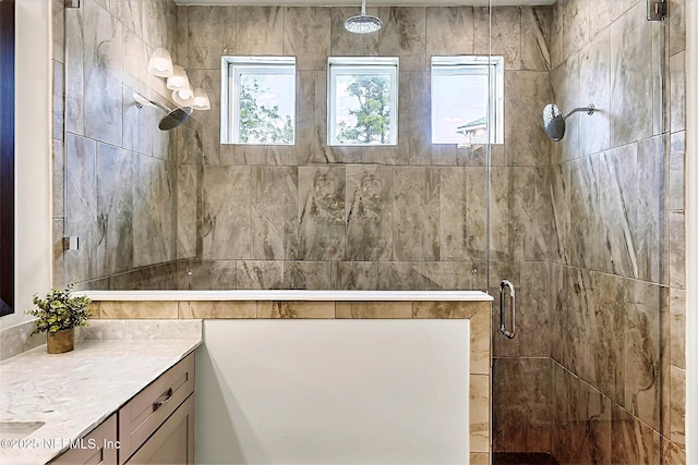 bathroom featuring a shower stall and vanity
