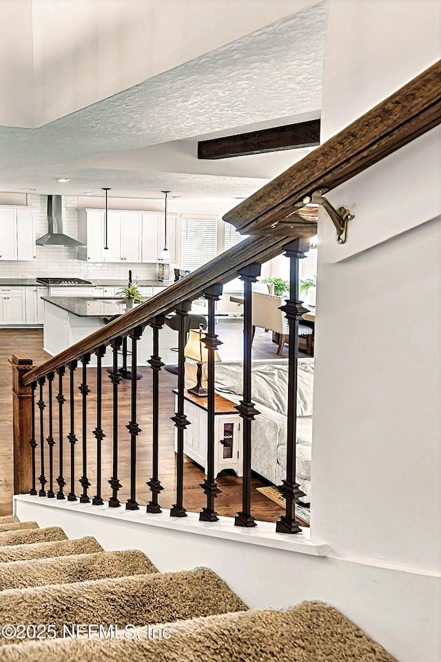stairway with wood finished floors
