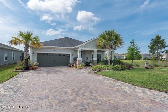 view of front of house with a garage, a porch, a front lawn, and decorative driveway