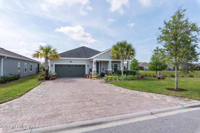 single story home featuring an attached garage, a front yard, and decorative driveway