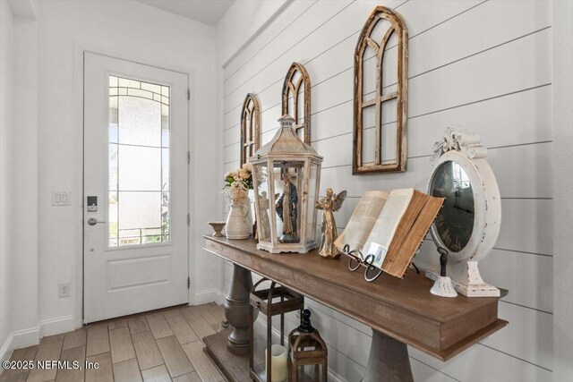 entrance foyer with wood finished floors and baseboards